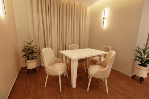 a room with a white table and chairs at Golden House - جولدن هاوس التجمع الخامس in Cairo