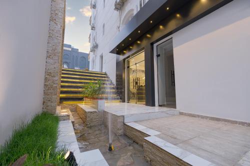a building with a staircase in front of it at Golden House - جولدن هاوس التجمع الخامس in Cairo