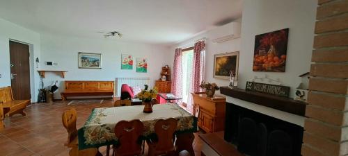 a living room with a table and a dining room at Casa rustica con vista meravigliosa in Offida