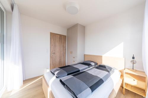 a bedroom with a large black and white bed at Residence Mozaika in Prague