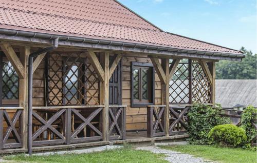 a wooden building with a red roof at Beautiful Apartment In Tumiany in Tumiany