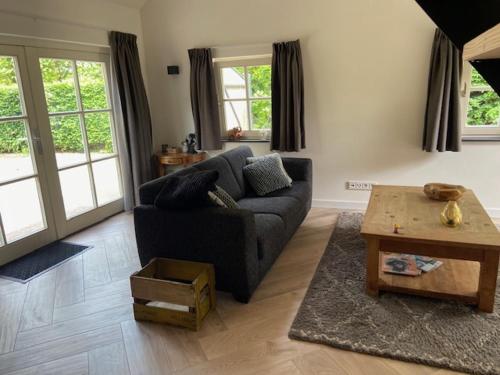 a living room with a couch and a coffee table at Op den Distelberg in Helvoirt