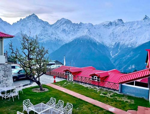 a view of a resort with mountains in the background at Hotel Rollingrang in Kalpa