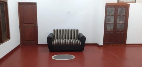 a chair sitting on a floor in a room at Villa Paradiso in Wadduwa