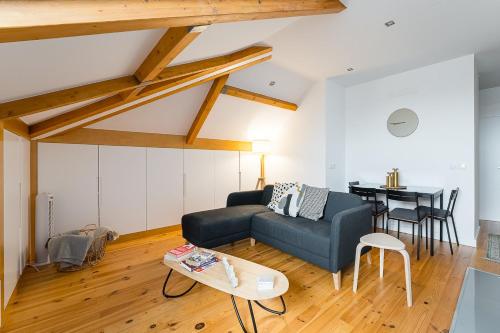 a living room with a couch and a table at GuestReady - Freixo Paradise view in Porto