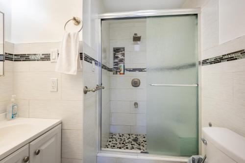 a bathroom with a shower with a glass door at KLO Guest House in Brooklyn