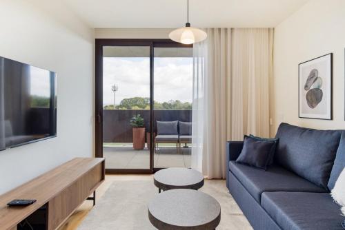 a living room with a couch and a table at GuestReady - Asaf's Magnolias Retreat in Vila Nova de Gaia