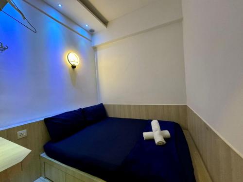 a teddy bear sitting on a bed in a room at SA Sutera Avenue Homestay Opposite Imago KK in Kota Kinabalu