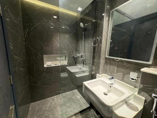 a bathroom with a sink and a mirror at Furnished studio استديو مفروش studio city in Dubai
