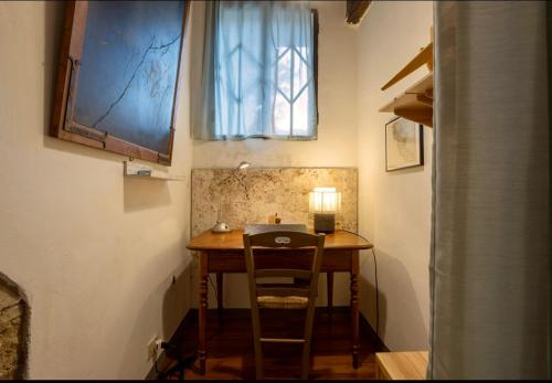 a table in a room with a chair and a window at Le Fonti di San Gimignano in San Gimignano