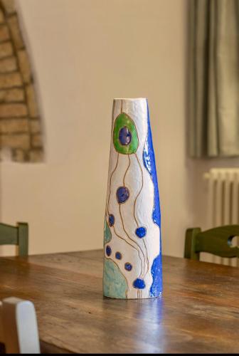 a vase sitting on top of a wooden table at Le Fonti di San Gimignano in San Gimignano
