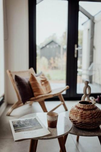 a living room with a coffee table and a chair at WØUD Tiny House in Epe