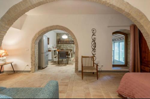 an archway in a room with a kitchen and a living room at Le Fonti di San Gimignano in San Gimignano