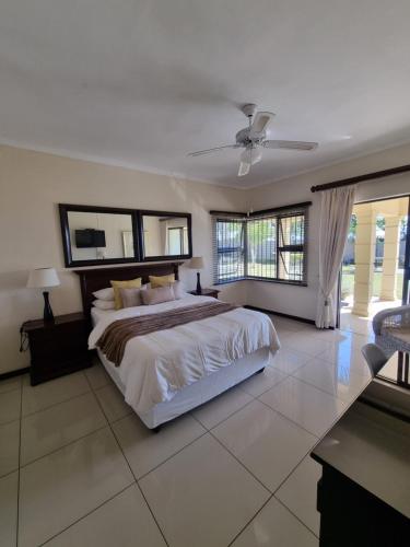 a large bedroom with a large bed and windows at The Executive 5 BnB in Manzini