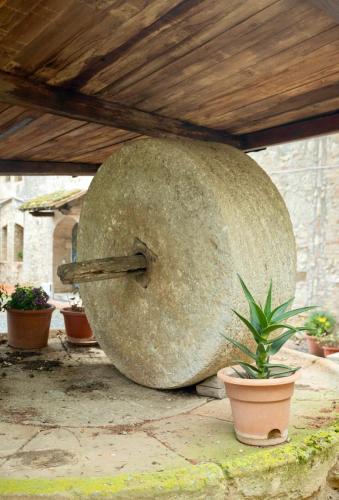 a large rock sitting on the ground with potted plants at Le Fonti di San Gimignano in San Gimignano
