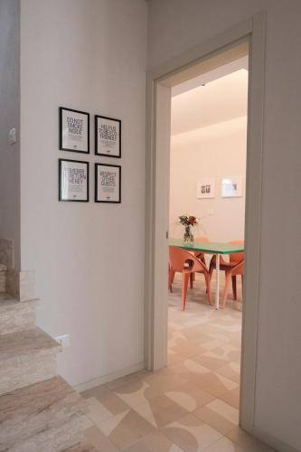 an open door into a dining room with a table at Famiglia Scirocco Guest House in Offida