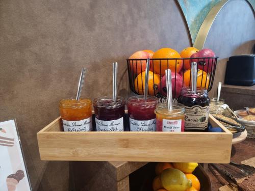 a wooden shelf with jars of jam and fruit at ibis Styles Dijon Sud Domaine De Beauregard 21600 Longvic in Dijon