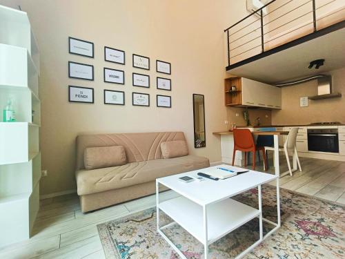 a living room with a couch and a table at YR Apartments Milan - Bocconi - Fashion Apartment in Milan