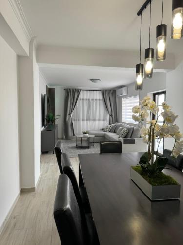 a living room with a couch and a table at Princess Retreat Beautiful Modern Aprt 2 min walk from Quarteira Beach in Quarteira