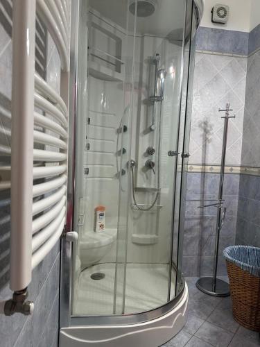 a glass shower in a bathroom with a sink at Casa d amare in Gioiosa Marea