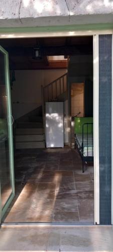 an empty room with a bed and a refrigerator at MELPO in Évyiros