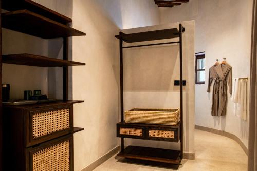 a dressing room with a mirror and a dresser at The Neela Boutique Hotel Stone Town in Zanzibar City