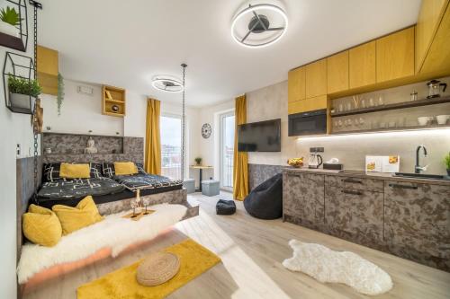 a living room with a bed and a kitchen at Internesto Brno Krenova in Brno