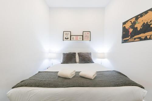 a bedroom with a white bed with two pillows at GuestReady - Bella's Downtown Apartment in Porto