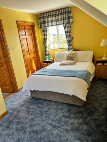 a bedroom with a large bed and a window at Dal Riada B&B in Gweedore