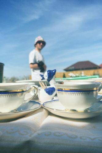 a table with two tea cups and saucers on it at Vadul Chiquita in Vadu