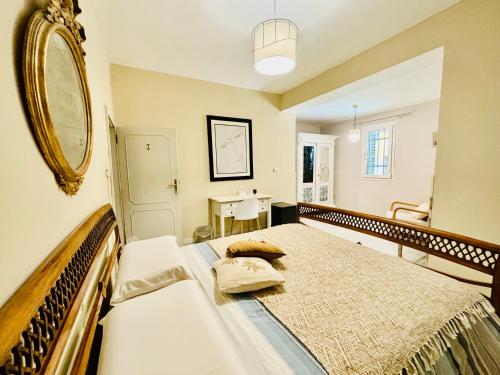 a bedroom with a large bed with a mirror on the wall at Dorsoduro House in Venice