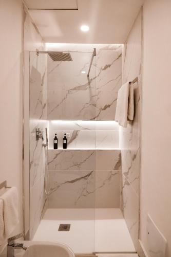 a bathroom with a shower with a sink and a toilet at ADOUNIA HOME in Naples