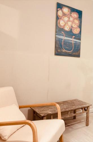 a room with a table and a chair and a painting at Dorsoduro House in Venice