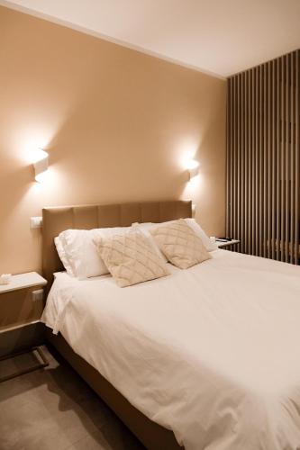 a bedroom with a large white bed with two pillows at ADOUNIA HOME in Naples