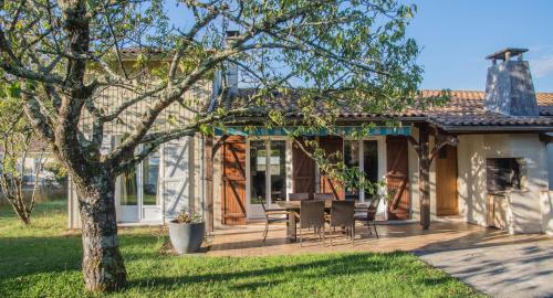 a house with a porch with a table and chairs at 3 bedrooms, very quiet, fully equiped, between Bordeaux and Saint-Emilion in Vayres
