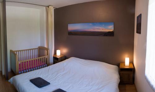 a bedroom with a bed and two candles on two tables at 3 bedrooms, very quiet, fully equiped, between Bordeaux and Saint-Emilion in Vayres