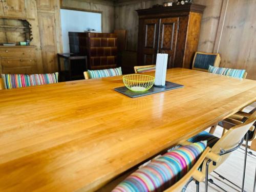 a wooden table with a bowl on top of it at Casa Cradd, Spacious House near Flims in Trin