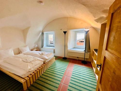 a small bedroom with a bed and a window at Casa Cradd, Spacious House near Flims in Trin