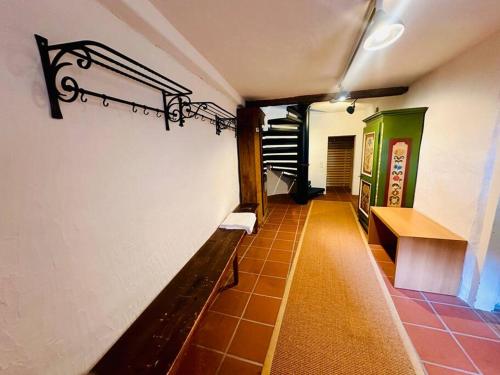a hallway with a bench and stairs in a building at Casa Cradd, Spacious House near Flims in Trin