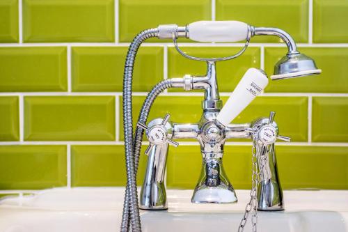 a kitchen sink faucet with a toothbrush at Round House East in Veryan