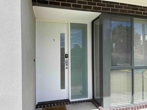 a sliding glass door in a room with windows at D104 Winston Fresh Fantastic in Braybrook
