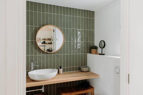 a bathroom with a sink and a mirror at Kos I Tiny house met grote tuin in Epe