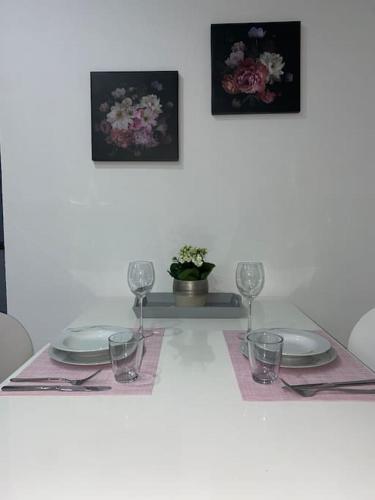 a table with plates and glasses on a white table at Ferienwohnung Privatunterkunft in Zweibrücken