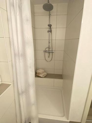 a shower with a white shower curtain in a bathroom at Ferienwohnung Privatunterkunft in Zweibrücken