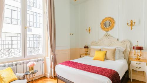 a bedroom with a white bed with yellow pillows at Luxury 3 Bedroom 2 Bathroom - AC - Louvre & Marais in Paris