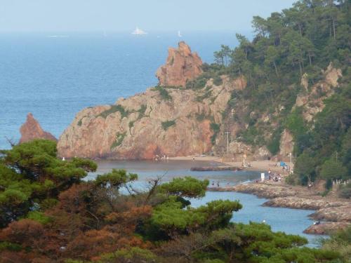 a view of a beach with people on the water at Vue baie à 5min de la plage 44m² avec parking in Théoule-sur-Mer
