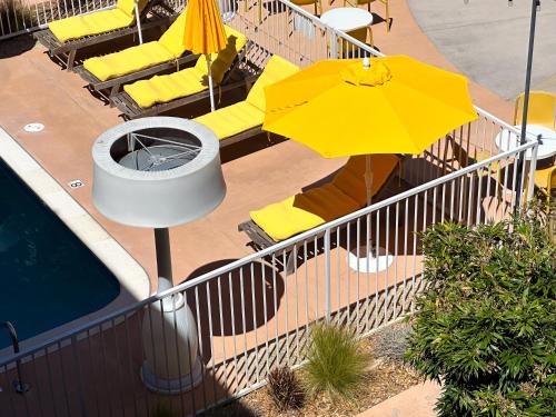 a yellow umbrella and chairs next to a swimming pool at Hotel Del Sol in San Francisco