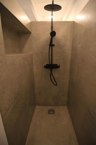 a shower with a light hanging from the ceiling at Studio Kaza Blanka - Saint Leu - Réunion in Saint-Leu