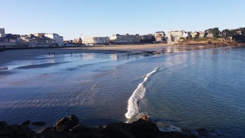 a view of a beach with buildings in the background at Loft atypique hyper centre à 5mn à pied de la plage de l'Écluse 2 à 8 personnes in Dinard