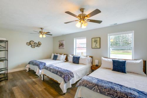 a bedroom with two beds and a ceiling fan at Group Getaway in Cadillac about 4 Mi to State Park! in Cadillac